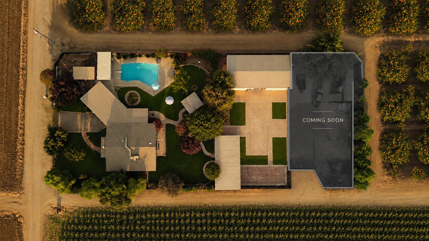 Aerial view of the property showing the garden, pool and the new event hall under construction